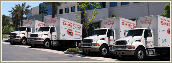 4 New Trucks Parked in Front of Building Banner Southern California Shredding